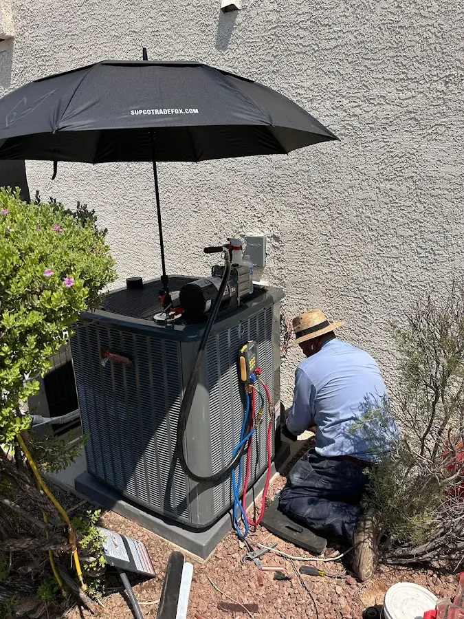 HVAC technician performing outdoor AC maintenance in Astoria